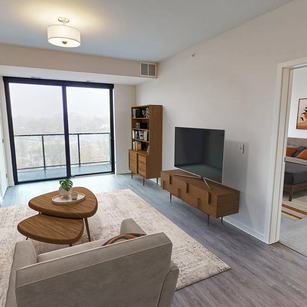 Bright, modern living room with light sofa, wooden furniture, and balcony access. A cozy bedroom is visible through an open doorway.